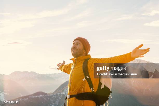 wanderer pausiert auf bergrücken auf berggipfeln, arme weit geöffnet in der luft. errungenschaften - gebirgskamm stock-fotos und bilder