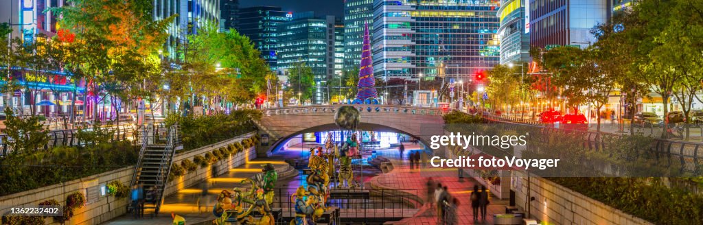 Seoul Cheonggyecheon Stream illuminated at night between skyscrapers panorama Korea