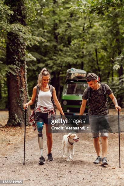 young couple with camper at road trip - dog camping stock pictures, royalty-free photos & images