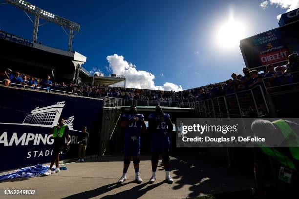 Darian Kinnard and Austin Dotson of the Kentucky Wildcats stand in the tunnel during the National Anthem prior to the game against the Iowa Hawkeyes...