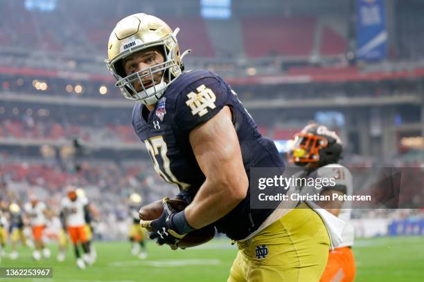 Michael Mayer of the Notre Dame Fighting Irish celebrates after scoring a touchdown in the second quarter against the Oklahoma State Cowboys during...