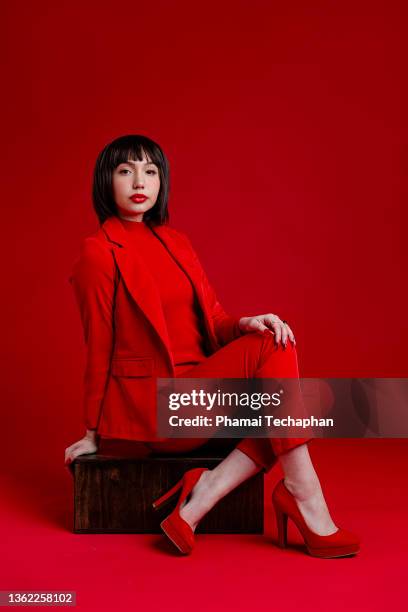 beautiful woman in red - pant suit stock pictures, royalty-free photos & images