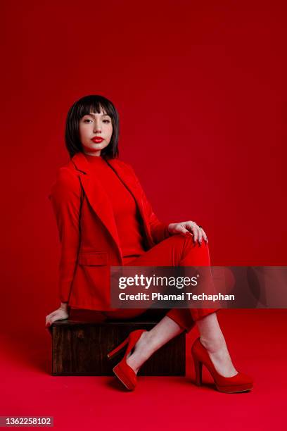 beautiful woman in red - women in suits stock pictures, royalty-free photos & images