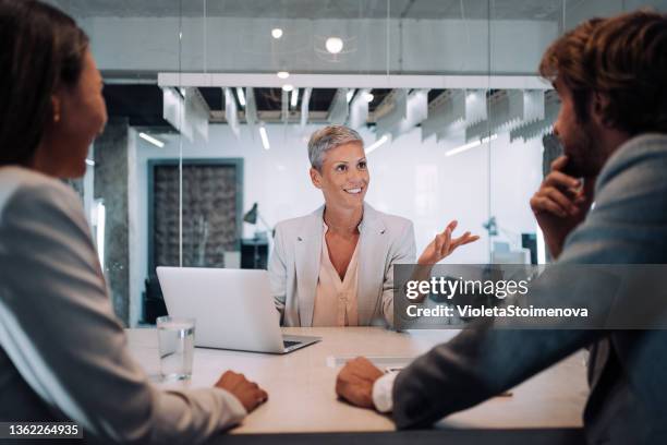 group of business persons talking in the office. - bank loan stockfoto's en -beelden