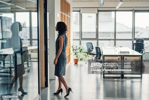 businesswoman walking in modern office. - person walking side view stock pictures, royalty-free photos & images