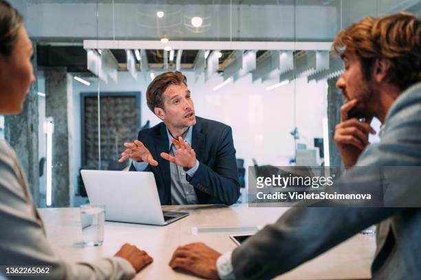 group of business persons talking in the office. - enterprise stockfoto's en -beelden