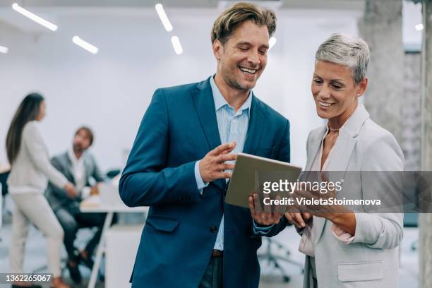 business people in the office. - couple standing stockfoto's en -beelden