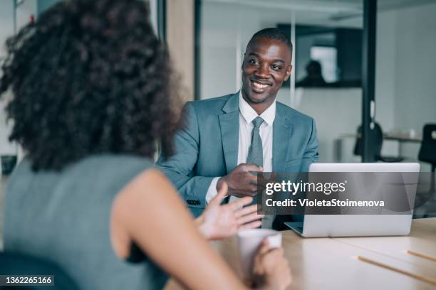 business partners in meeting. - businessman in black suit stock pictures, royalty-free photos & images