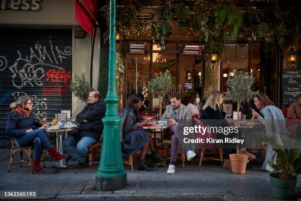 Parisians eat on the terrace of a restaurant on New Year's Day on January 01, 2022 in Paris, France. France welcomes the New Year with surging...