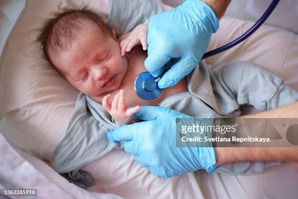 doctor uses stethoscope to listen to baby - child coronavirus sick stock pictures, royalty-free photos & images