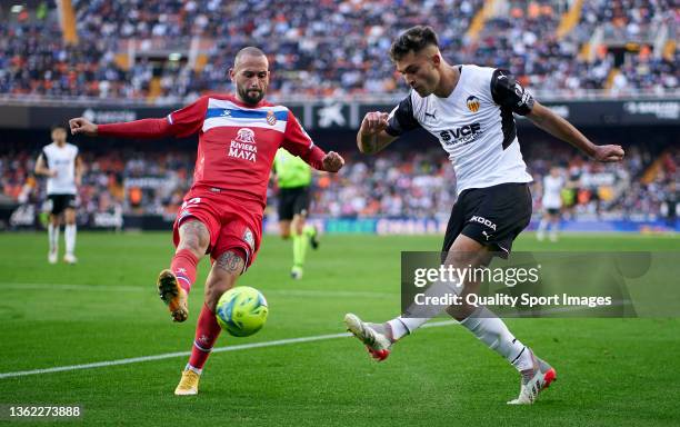 Hugo Duro of Valencia CF is close down by Aleix Vidal of RCD Espanyol during the La Liga Santander match between Valencia CF and RCD Espanyol at...