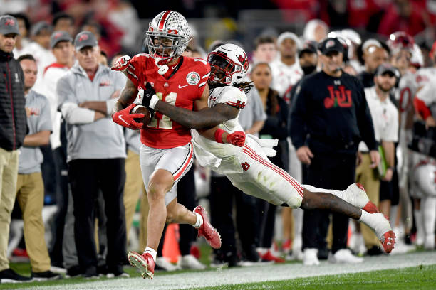 Jaxon Smith-Njigba of the Ohio State Buckeyes carries the ball after a reception against the Utah Utes during the second half in the Rose Bowl Game