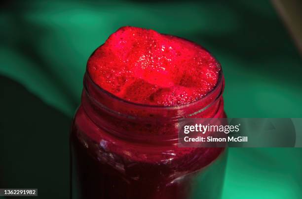 beetroot, apple and mixed berry smoothie served in a glass jar on an outdoor cafe table - beetroot juice stock-fotos und bilder