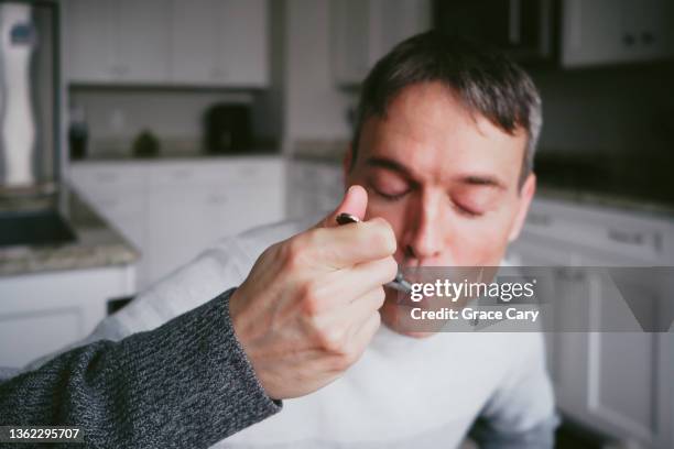 man enjoys meal at home - satisfaction face stock pictures, royalty-free photos & images