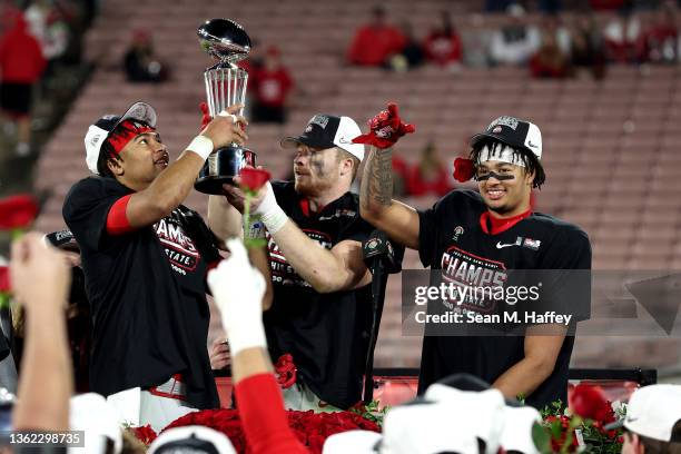 Stroud, Tommy Eichenberg and Jaxon Smith-Njigba of the Ohio State Buckeyes raise the trophy after defeating the Utah Utes 48-45 in the Rose Bowl Game...