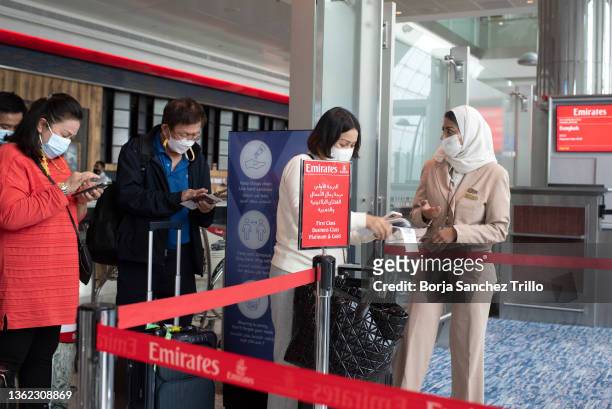 Emirates flight attendants verify traveler documents at Dubai International Airport on January 01, 2022 in Dubai, UAE. Inter-country journeys made...