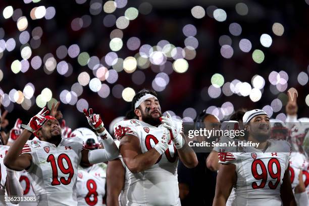 Devin Kaufusi, Bryson Reeves, and Tennessee Pututau of the Utah Utes look on during a memorial for fallen teammates during the first half of the Rose...