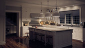 Ultra modern white kitchen in low lighting