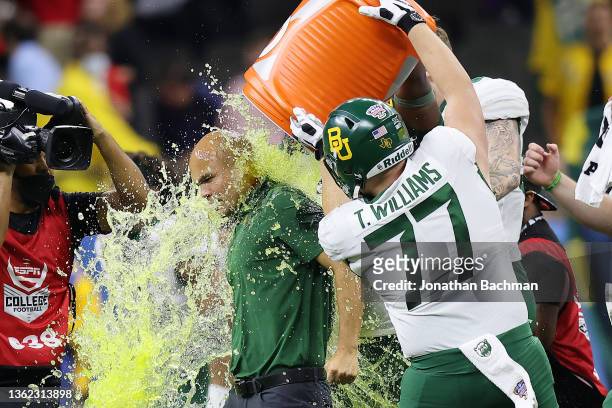Tate Williams of the Baylor Bears dumps Gatorade on head coach Dave Aranda after defeating the Mississippi Rebels 21-7 in the Allstate Sugar Bowl at...