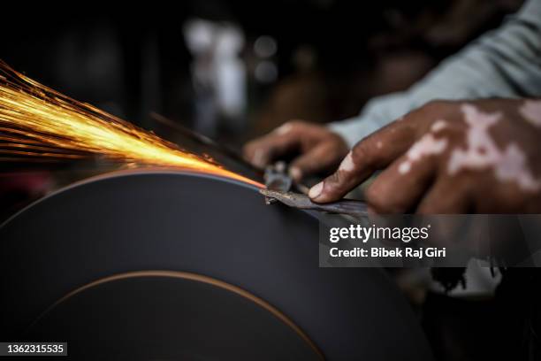 a blacksmith sharpening a knife/scissors; india - sharpening stock pictures, royalty-free photos & images