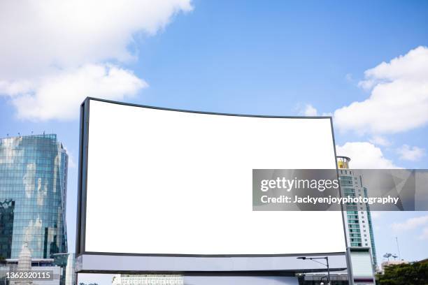 illuminated billboards in a modern business district, low angle view - achtergrond krijtbord blauw stockfoto's en -beelden