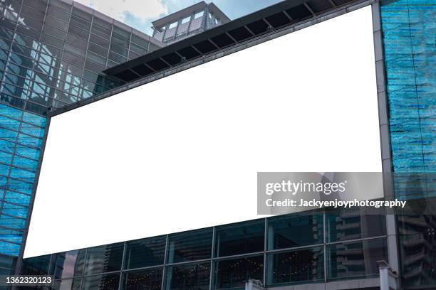 illuminated billboards in a modern business district, low angle view - poster mockup stock pictures, royalty-free photos & images