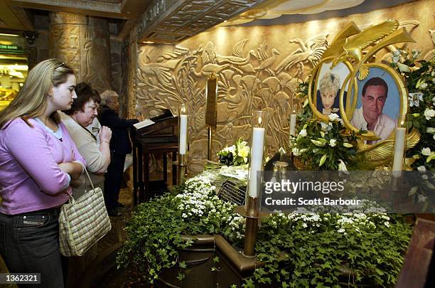 People look at the memorial to Diana, Princess of Wales and Dodi Al Fayed in Harrods department store August 31, 2002 in London, England. Princess...