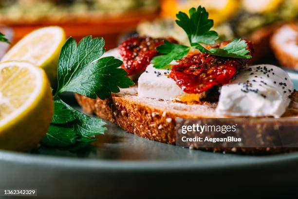 delicious tartine with dried tomatoes and feta cheese - crostini stock pictures, royalty-free photos & images