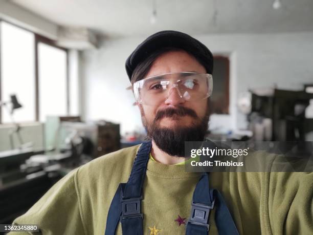 factory worker taking selfies - occupation hats stock pictures, royalty-free photos & images