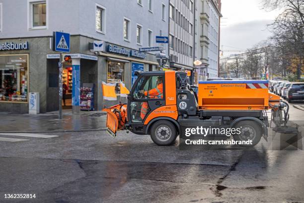 small snowplow in munich - winterdienst stockfoto's en -beelden