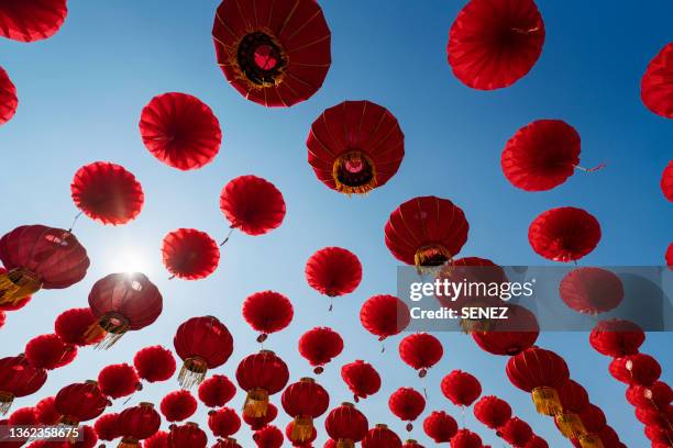 low angle view of chinese lanterns hanging against sky - lanterna foto e immagini stock