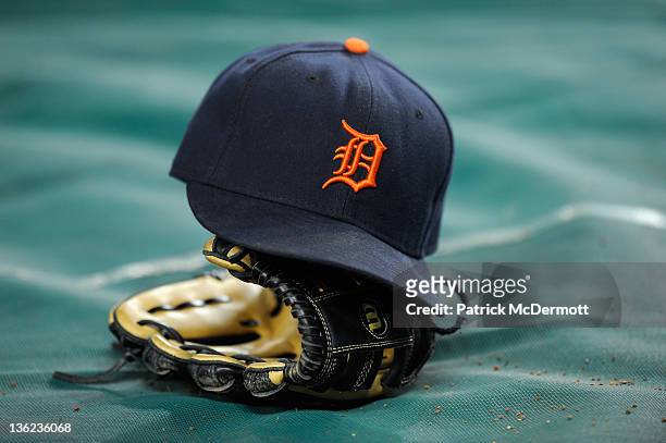 Detail of a Detroit Tigers hat and glove are seen during warm ups against the New York Yankees during Game Five of the American League Championship...