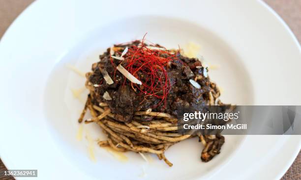 spaghetti with huitlacoche (corn smut) sauce with parmesan cheese in a bowl - huitlacoche stock pictures, royalty-free photos & images