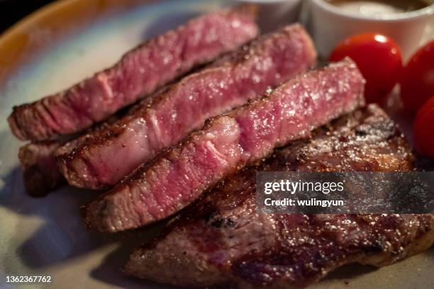grilled medium rib eye steak at dinner time - rib eye steak stock-fotos und bilder