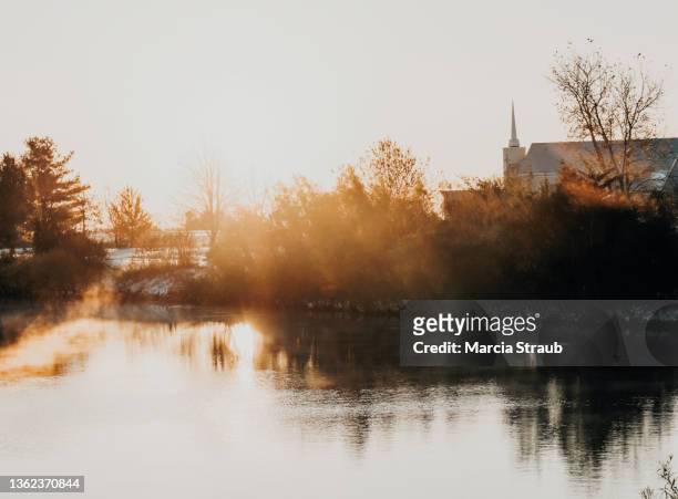 sunrise and  country church with steeple and spiritual light - easter sunrise 個照片及圖片檔