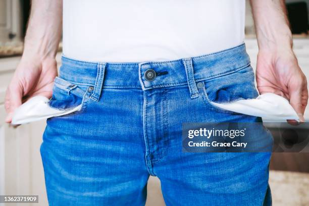 midsection of broke man with empty pockets - pocket stock pictures, royalty-free photos & images