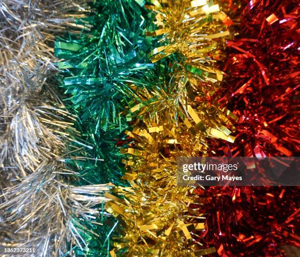 tinsel colours - red tinsel stock pictures, royalty-free photos & images