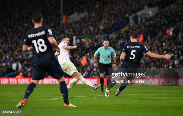 Stuart Dallas of Leeds United scores their sides second goal whilst under pressure from James Tarkowski of Burnley during the Premier League match...