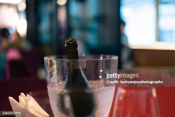 bottle of champagnes in ice bucket - ice bucket stock-fotos und bilder