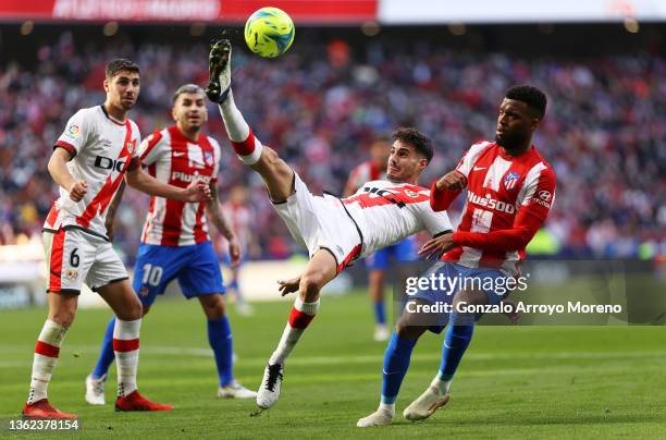 Oscar Valentin of Rayo Vallecano clears the ball whilst under pressure from Thomas Lemar of Atletico Madrid during the LaLiga Santander match between...