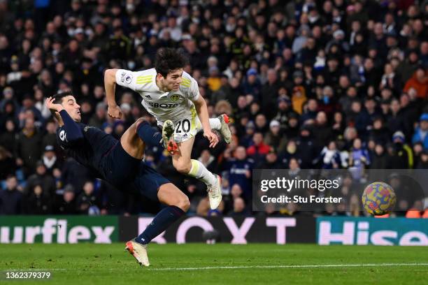 Daniel James of Leeds United scores their sides third goal whilst under pressure from Matthew Lowton of Burnley during the Premier League match...