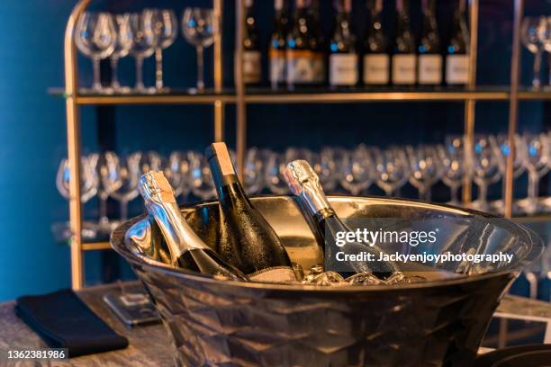 bottle of champagnes in ice bucket - champagne cork stock pictures, royalty-free photos & images