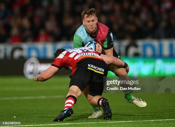 Alex Dombrandt of Harlequins is tackled by Ruan Ackermann of Gloucester during the Gallagher Premiership Rugby match between Gloucester Rugby and...