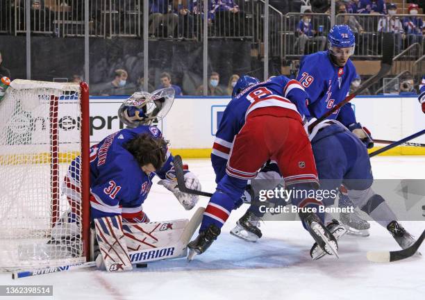 Igor Shesterkin of the New York Rangers has his helmet knocked off as he makes the first period save on Ross Colton of the Tampa Bay Lightning at...