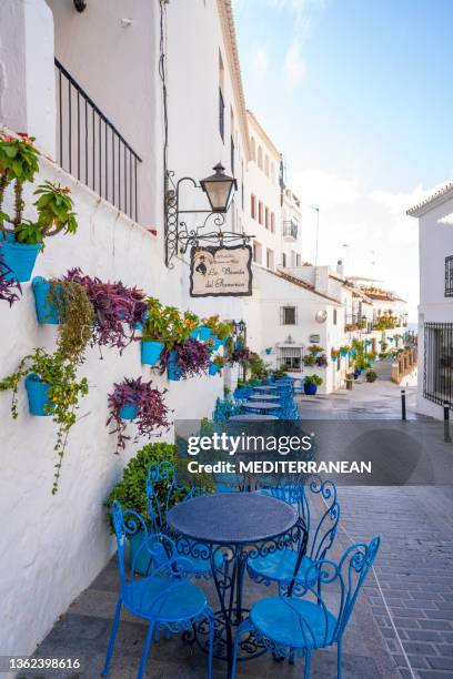 mijas village blue chairs in costa del sol  mediterranean whitew - málaga stockfoto's en -beelden