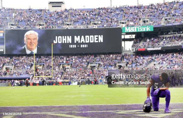 Tyus Bowser of the Baltimore Ravens kneels in the endzone before a moment of silence is recognized for former NFL coach John Madden before the game...