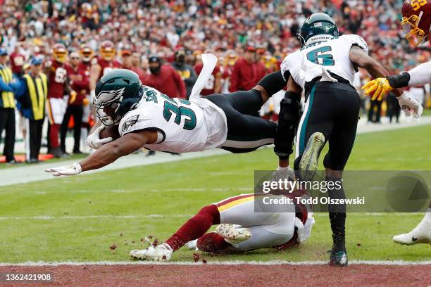 Boston Scott of the Philadelphia Eagles dives into the end zone for a touchdown during the third quarter against the Washington Football Team at...