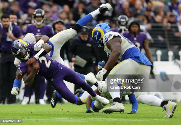 Tyler Huntley of the Baltimore Ravens runs with the ball as Tyus Bowser of the Baltimore Ravens tackles in the third quarter of at M&T Bank Stadium...