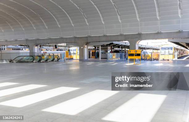 new modern train station with ecalators and trains, background with copy space - sydney train stock pictures, royalty-free photos & images