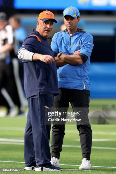Head coach Vic Fangio of the Denver Broncos and head coach Brandon Staley of the Los Angeles Chargers talk during warm ups prior to the game at SoFi...